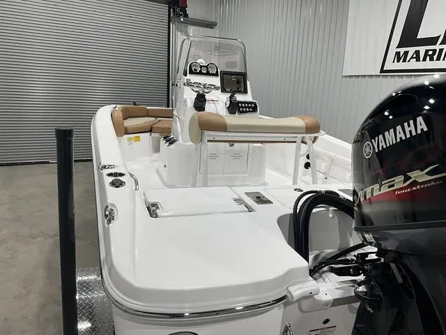 Slide: The Image of 2025 NauticStar 191 Hybrid boat with Yamaha engine in a garage setting. - 15