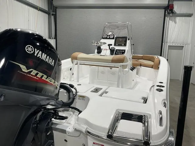Slide: The Image of 2025 NauticStar 191 Hybrid boat with Yamaha engine in a garage setting. - 16