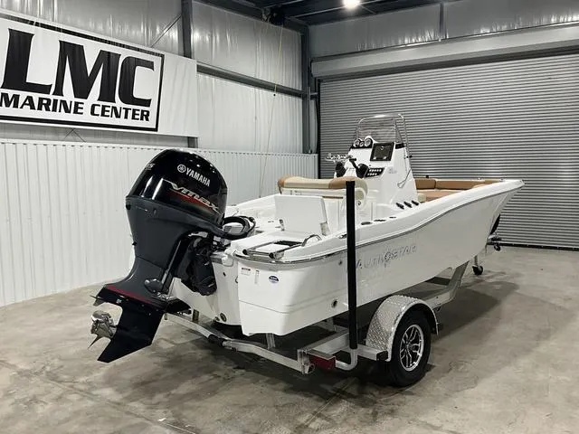 Slide: The Image of 2025 NauticStar 191 Hybrid boat with Yamaha engine in a marine center showroom. - 4