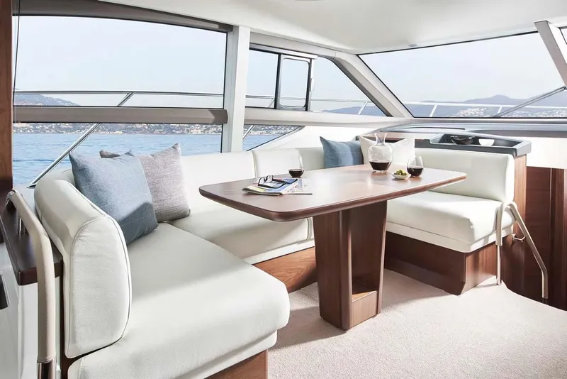 Slide: The Image of Luxurious interior of 2025 Princess 50 Flybridge yacht with elegant seating and table. - 6