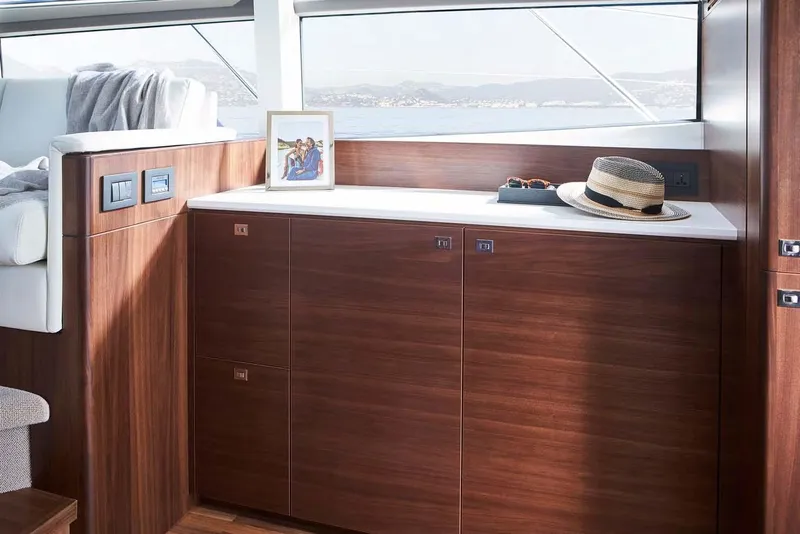 Slide: The Image of Luxurious interior of 2025 Princess 50 Flybridge yacht with wooden cabinetry and scenic view. - 7