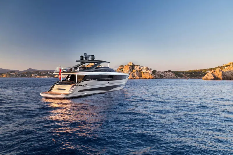 Slide: The Image of Luxurious 2025 Princess Y95 Motor Yacht cruising on serene blue waters at sunset. - 1