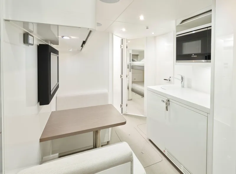 Slide: The Image of Luxurious interior of 2025 Princess Y95 Motor Yacht with modern kitchenette and seating area. - 23