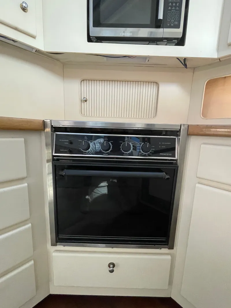 Slide: The Image of Interior of 1997 Carver 405 yacht bedroom with bed, wooden cabinets, and window. - 14