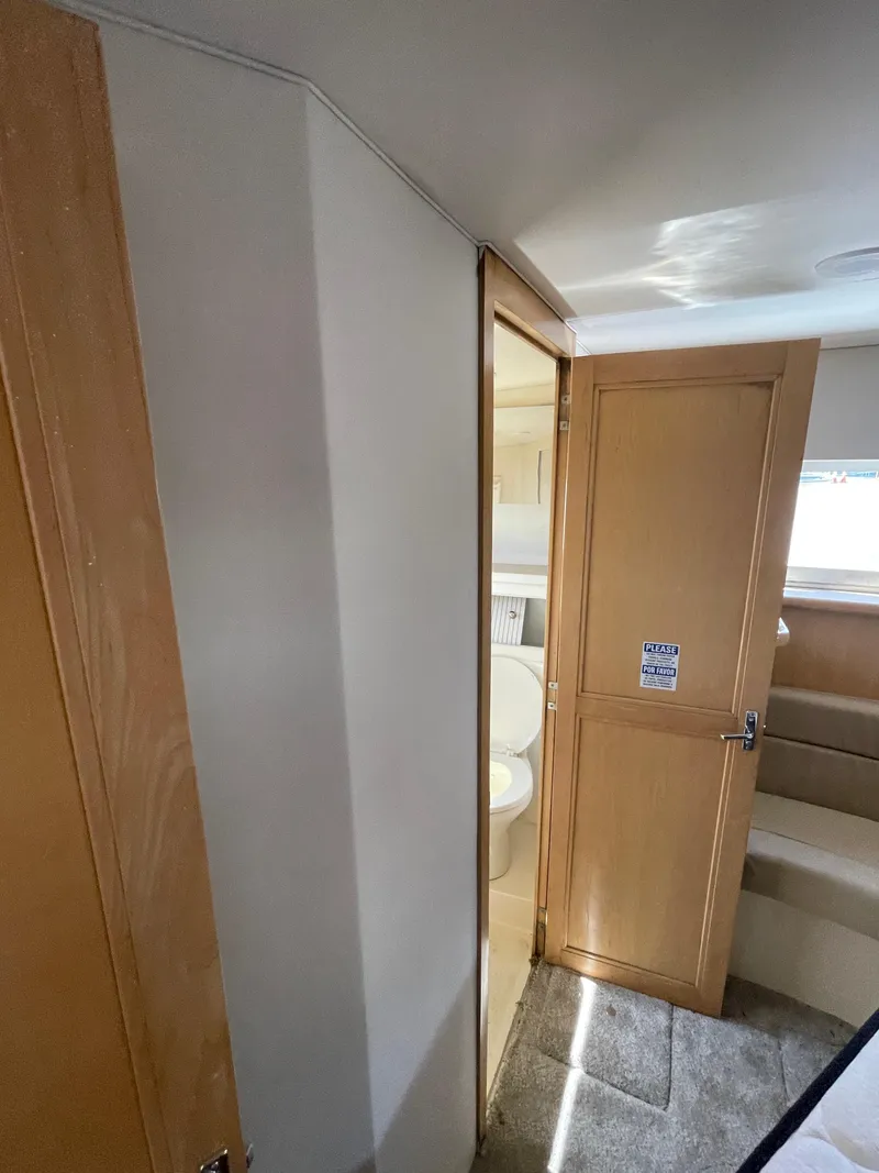 Slide: The Image of Interior of a 1997 Carver 405 yacht showing a bathroom and wooden door. - 18