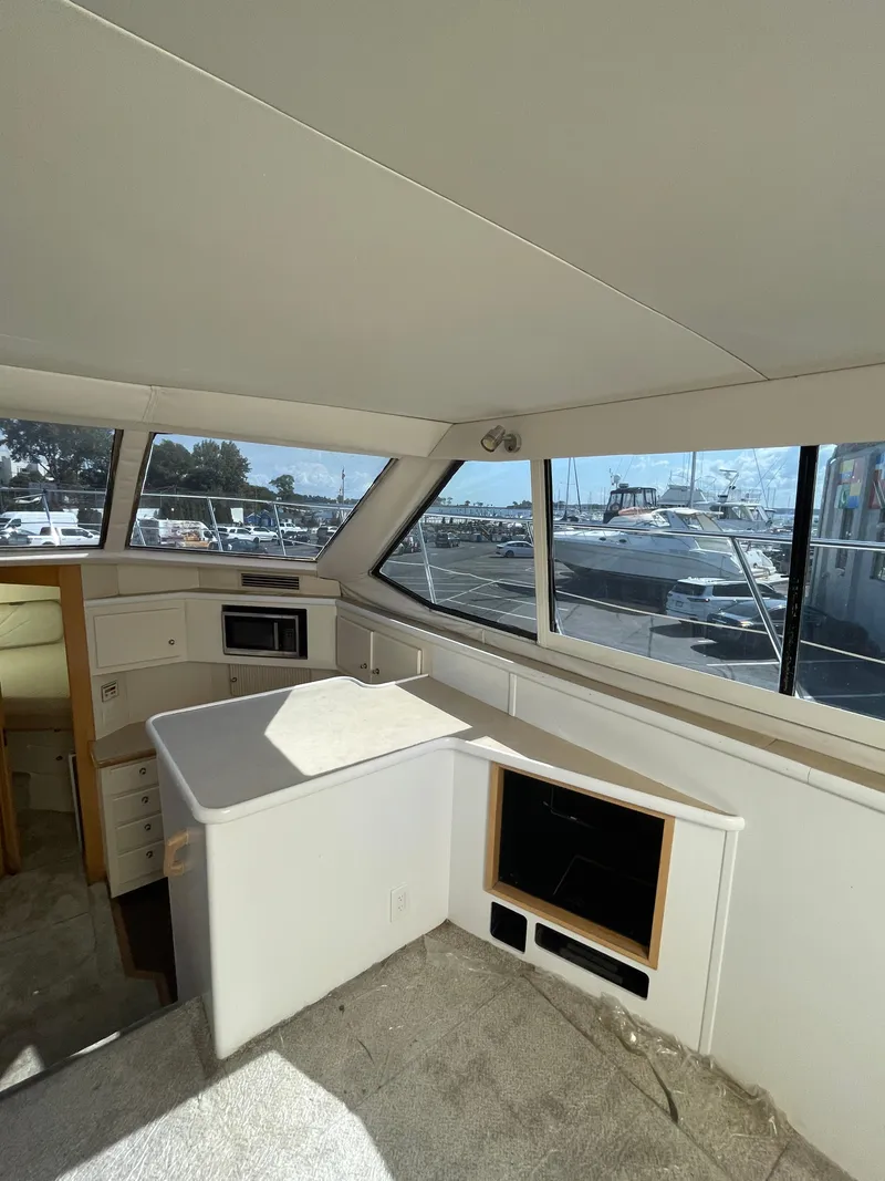 Slide: The Image of Interior of 1997 Carver 405 yacht with spacious cabin and large windows. - 26