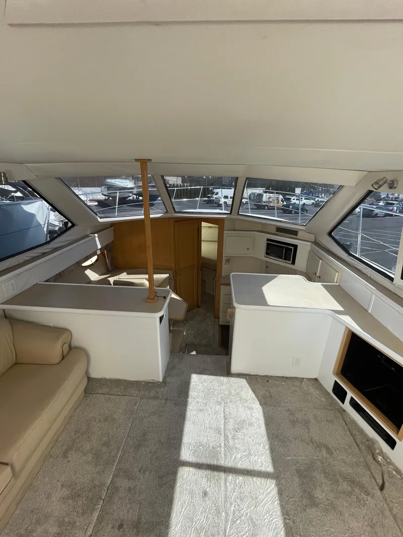 Slide: The Image of Interior of a 1997 Carver 405 yacht with spacious seating and kitchenette. - 29