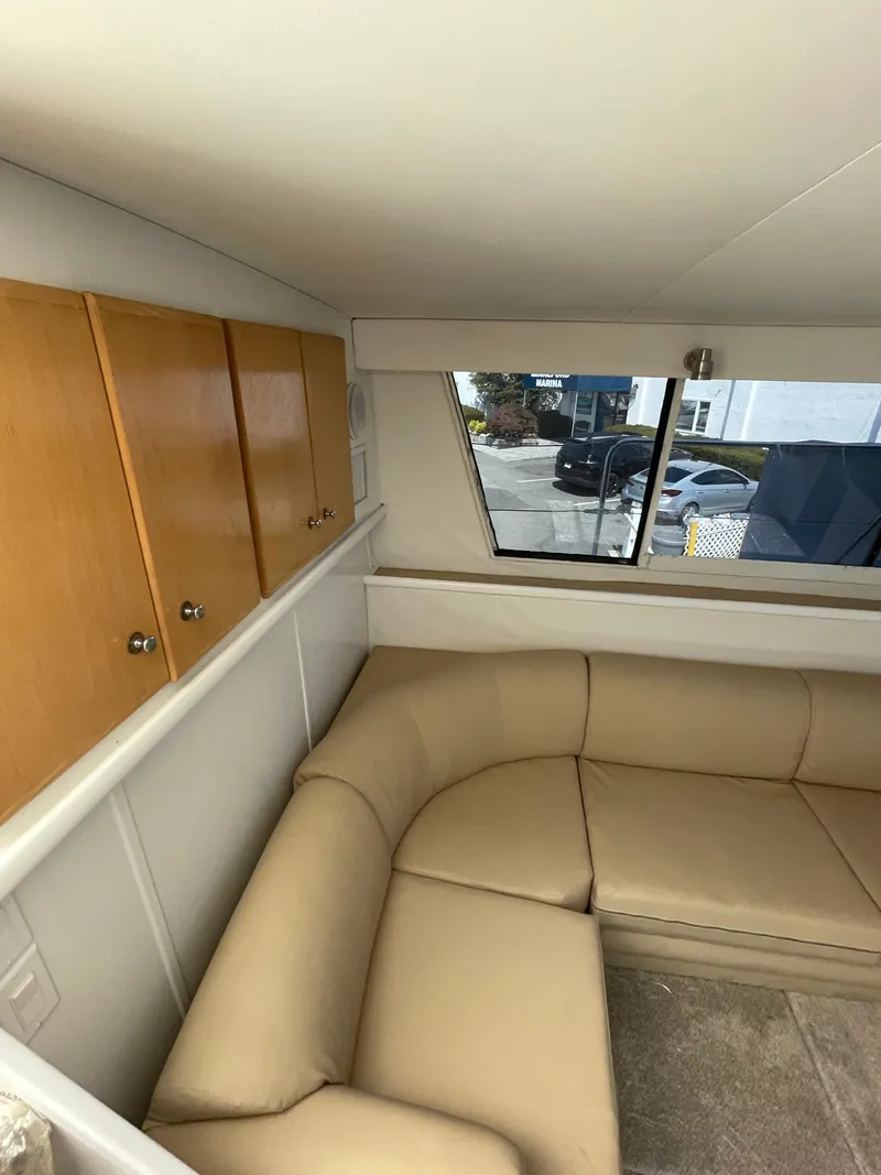 Slide: The Image of Interior of 1997 Carver 405 yacht with beige seating and wooden cabinets. - 30