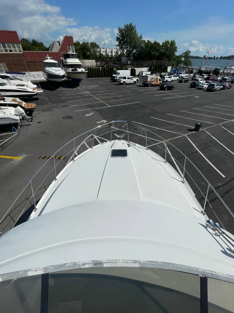 Slide: The Image of View from the bow of a 1997 Carver 405 yacht in a marina parking lot. - 36