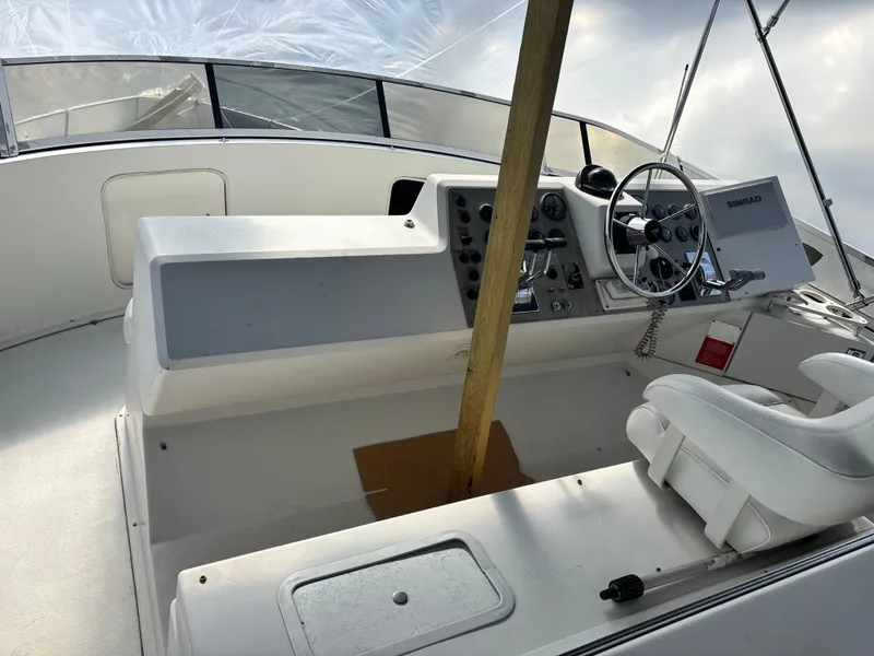 Slide: The Image of 1997 Carver 405 boat helm with steering wheel and control panel. - 10