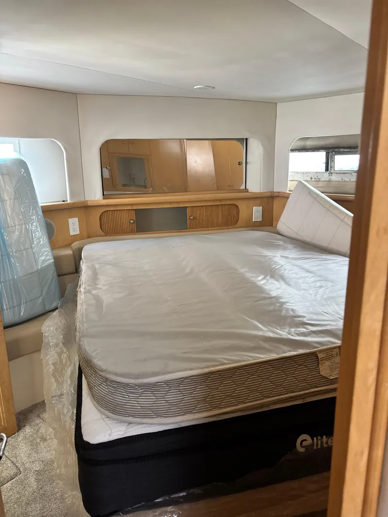 Slide: The Image of Interior of 1997 Carver 405 yacht bedroom with bed and wooden cabinetry. - 12