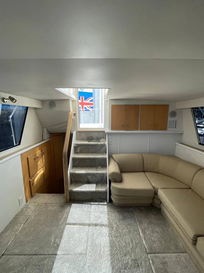Slide: The Image of Interior of 1997 Carver 405 yacht with beige sofa and wooden cabinets. - 16