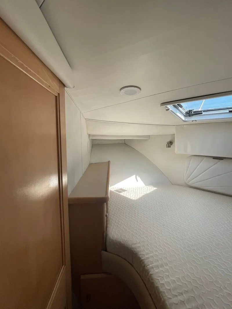 Slide: The Image of Interior cabin of a 1997 Carver 405 yacht with a bed and window. - 19