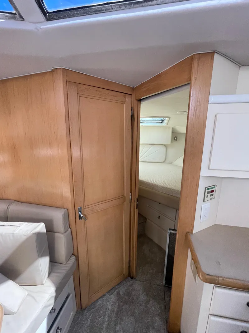 Slide: The Image of Interior of 1997 Carver 405 yacht showing cabin entrance and seating area. - 25