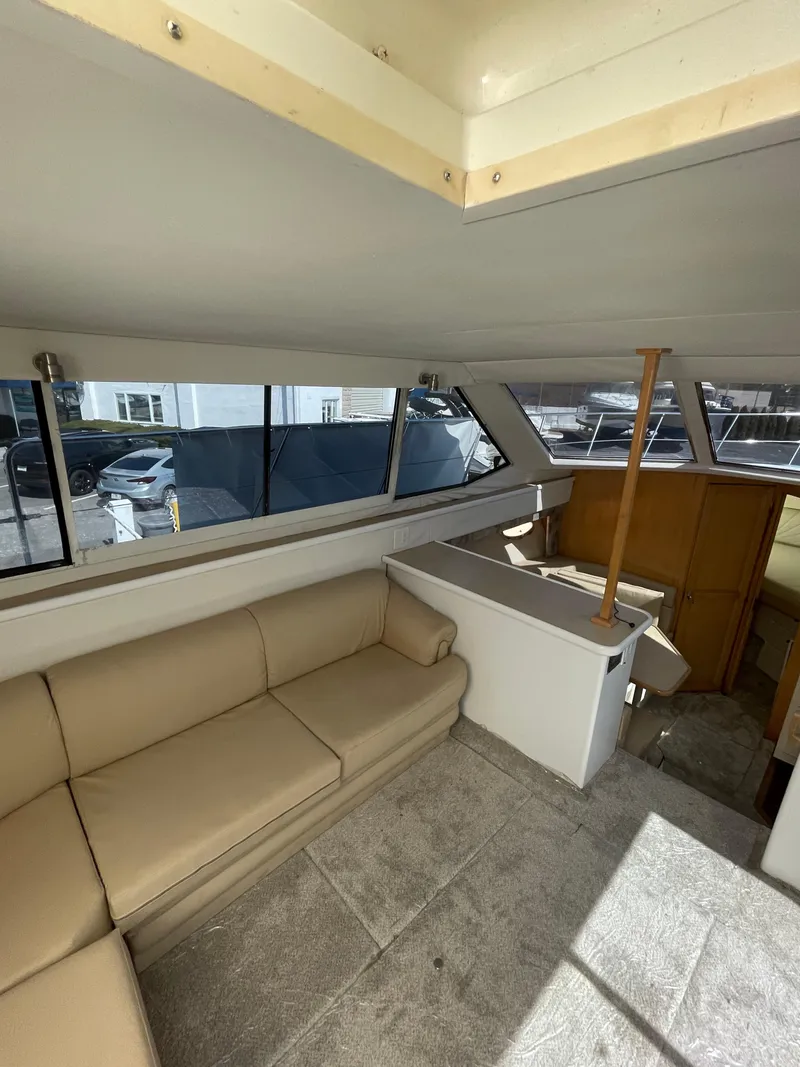 Slide: The Image of Interior of a 1997 Carver 405 yacht with beige seating and large windows. - 31