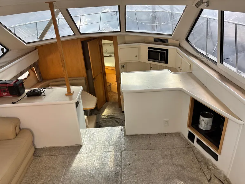 Slide: The Image of Interior of a 1997 Carver 405 yacht with spacious cabin and kitchenette. - 9