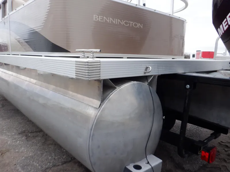 Slide: The Image of 2011 Bennington 22 SSL pontoon boat, side view, showcasing aluminum pontoons and deck. - 12
