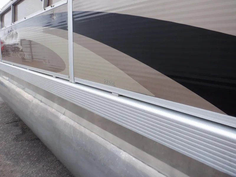 Slide: The Image of 2011 Bennington 22 SSL pontoon boat side view with sleek design. - 14