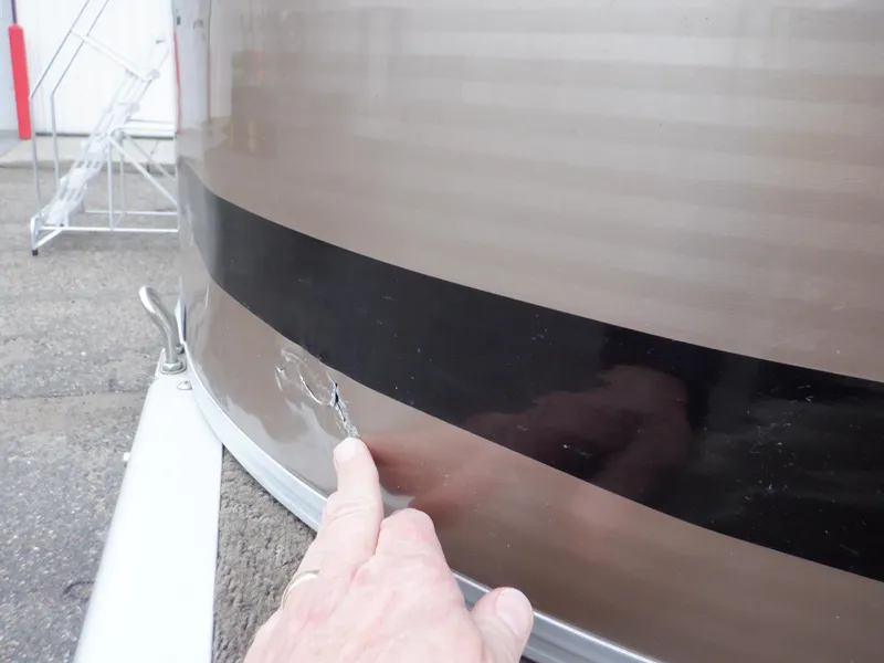 Slide: The Image of Close-up of damage on 2011 Bennington 22 SSL boat exterior. - 22