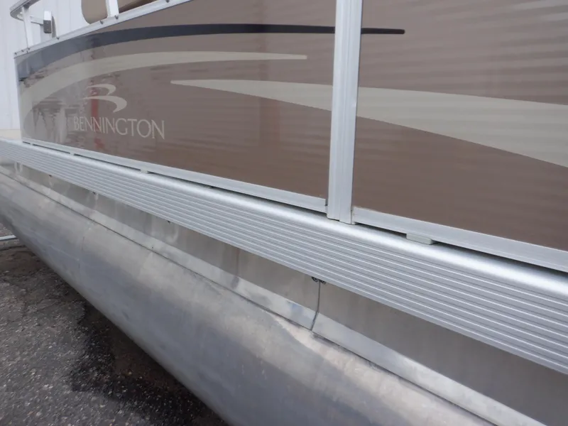 Slide: The Image of 2011 Bennington 22 SSL pontoon boat side view with sleek design. - 24