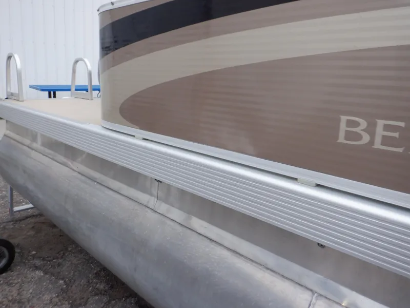 Slide: The Image of 2011 Bennington 22 SSL pontoon boat, side view with aluminum railing and beige exterior. - 25