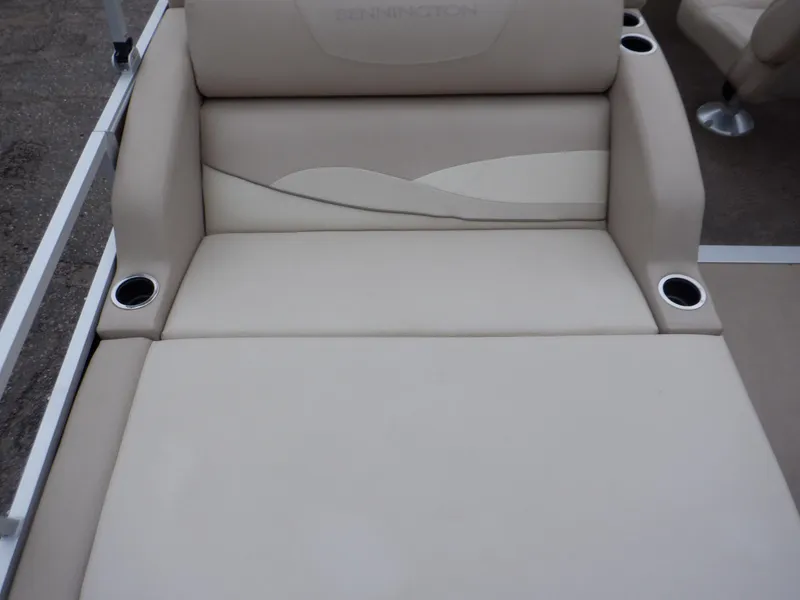Slide: The Image of 2011 Bennington 22 SSL boat seat with beige upholstery and built-in cup holders. - 29