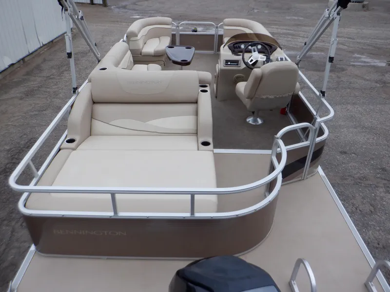 Slide: The Image of 2011 Bennington 22 SSL pontoon boat with beige seating and steering console. - 3