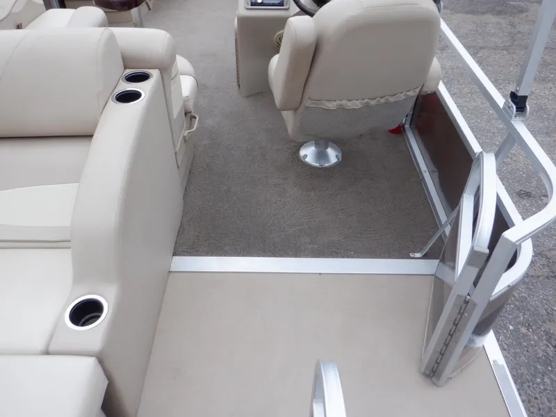 Slide: The Image of Interior of 2011 Bennington 22 SSL pontoon boat with beige seating and cup holders. - 30