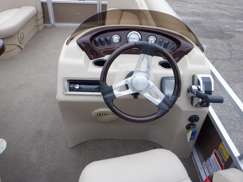 Slide: The Image of 2011 Bennington 22 SSL boat dashboard with steering wheel and control panel. - 31