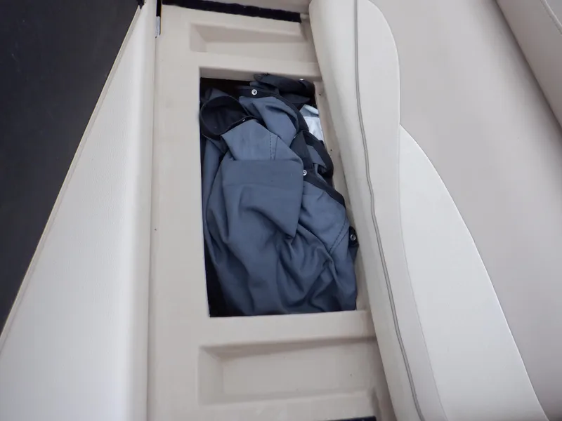 Slide: The Image of Storage compartment in 2011 Bennington 22 SSL boat with clothing inside. - 32