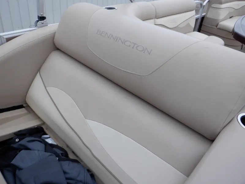 Slide: The Image of 2011 Bennington 22 SSL boat interior with beige seating and cup holders. - 33
