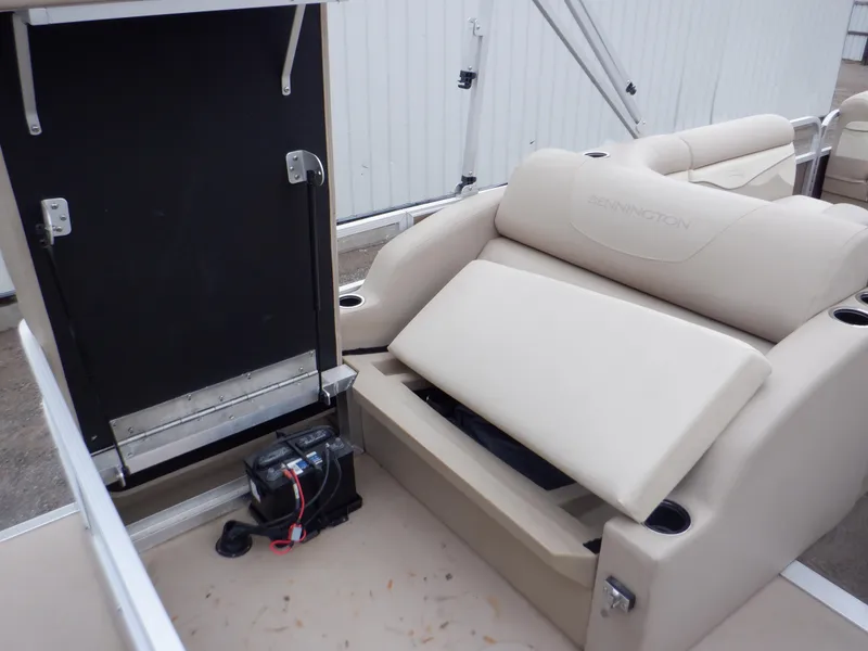 Slide: The Image of 2011 Bennington 22 SSL boat interior with beige seating and storage compartment. - 34