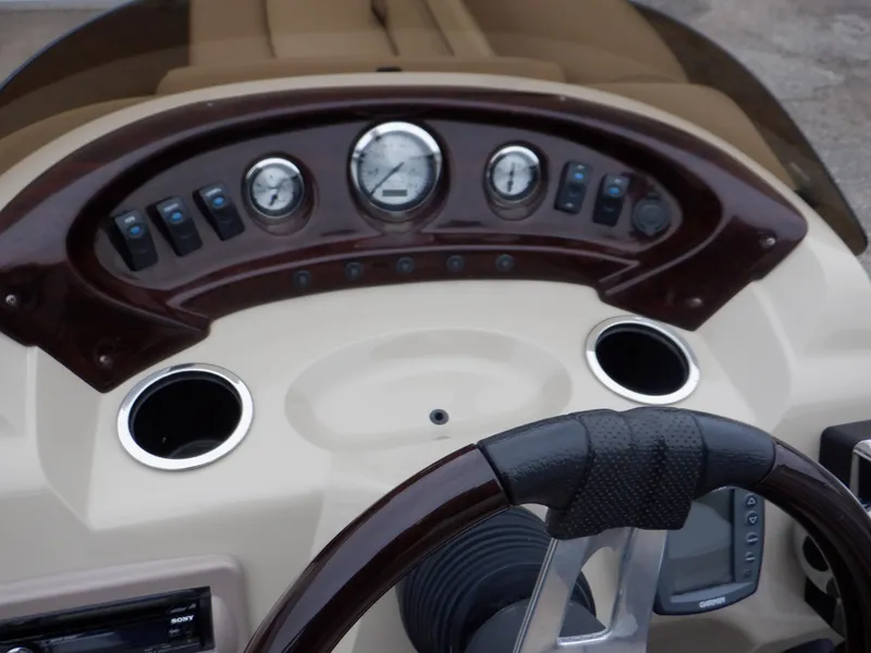 Slide: The Image of Dashboard of 2011 Bennington 22 SSL boat with gauges and steering wheel. - 38