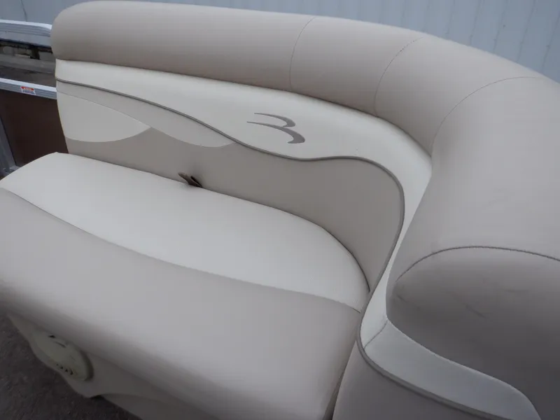 Slide: The Image of 2011 Bennington 22 SSL boat seat with beige upholstery and logo detail. - 49