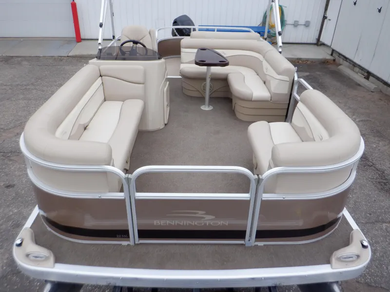 Slide: The Image of 2011 Bennington 22 SSL pontoon boat with beige seating and a central table. - 5