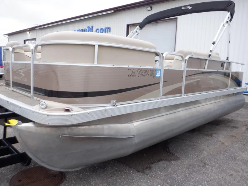 Slide: The Image of 2011 Bennington 22 SSL pontoon boat with beige exterior, parked on a trailer. - 7