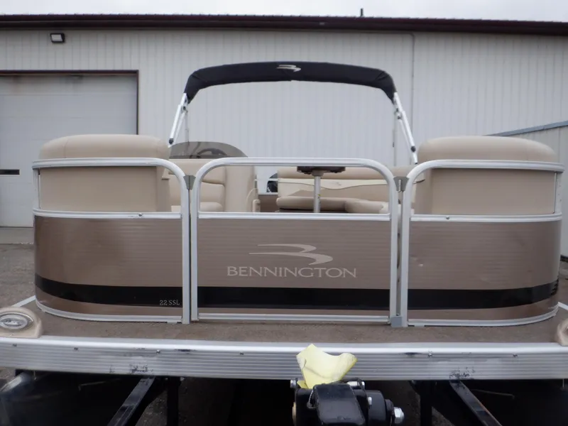 Slide: The Image of 2011 Bennington 22 SSL pontoon boat with beige seating and black canopy. - 8