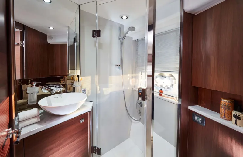 Slide: The Image of Luxurious bathroom in 2025 Princess V50 Open yacht with modern fixtures and wood accents. - 11