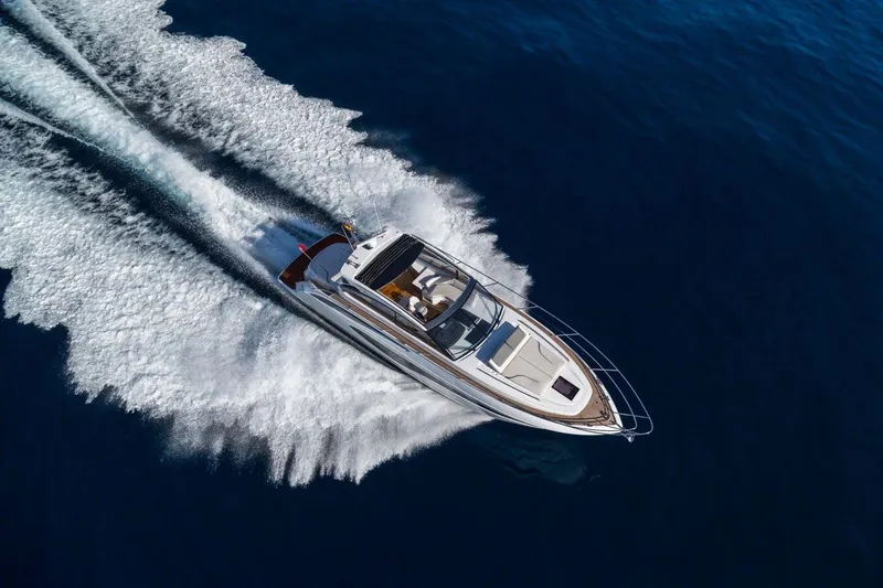 Slide: The Image of Princess V50 Open 2025 yacht cruising on open water, aerial view. - 2
