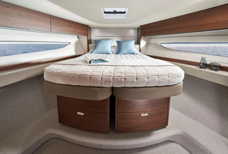 Slide: The Image of Luxurious 2025 Princess V50 Open yacht cabin with elegant wood finishes and cozy bedding. - 24