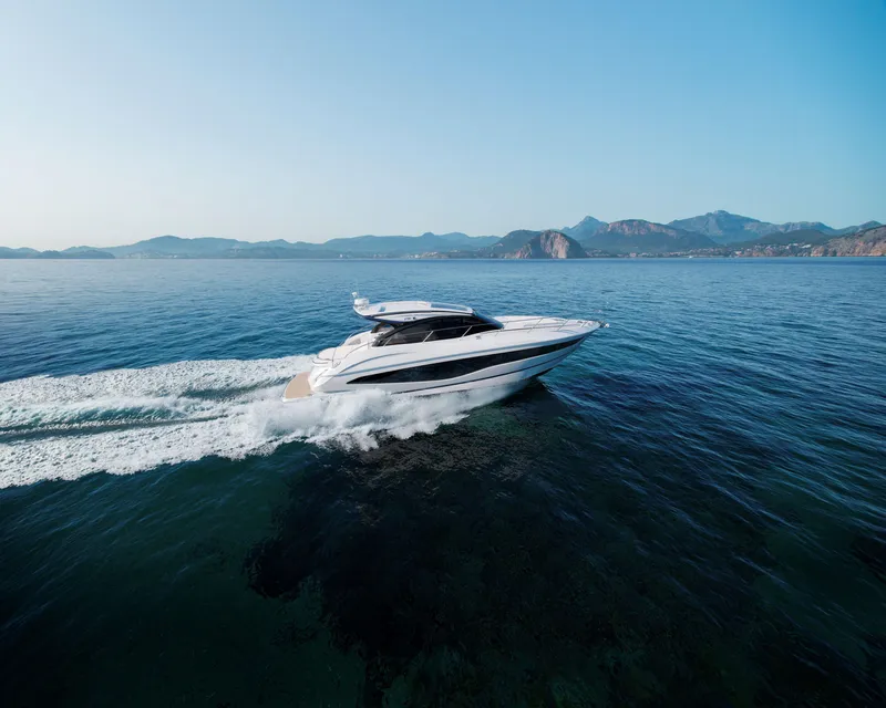 Slide: The Image of 2025 Princess V50 Open yacht cruising on open sea with scenic mountain backdrop. - 3