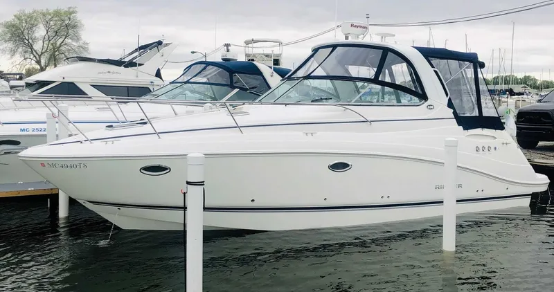 Slide: The Image of 2008 Rinker 330 Express Cruiser docked at marina, featuring sleek white design. - 4