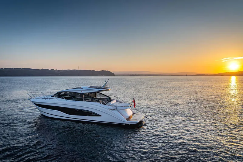 Slide: The Image of 2025 Princess V55 Express yacht cruising at sunset on open water. - 0