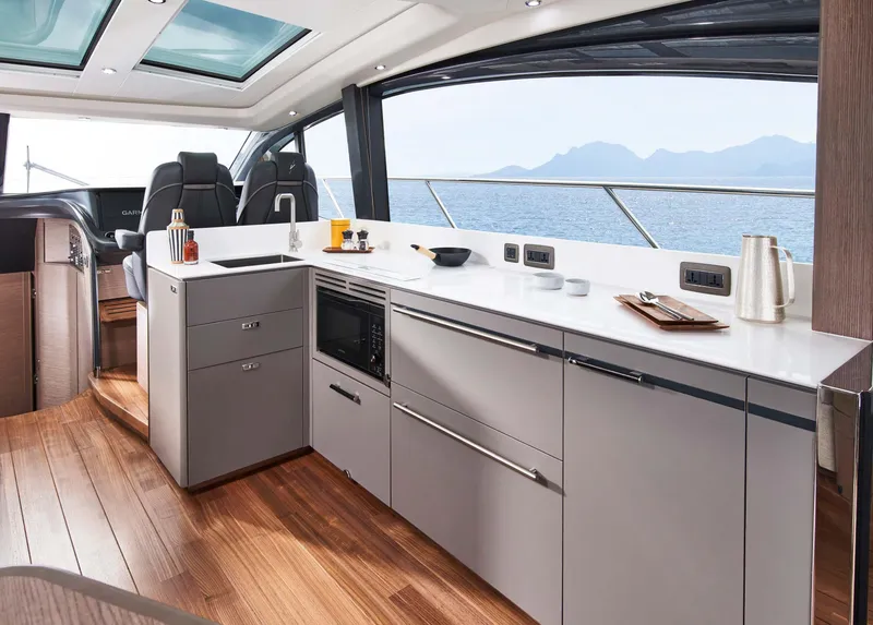 Slide: The Image of Luxurious interior of 2025 Princess V55 Express yacht with modern kitchen and ocean view. - 12