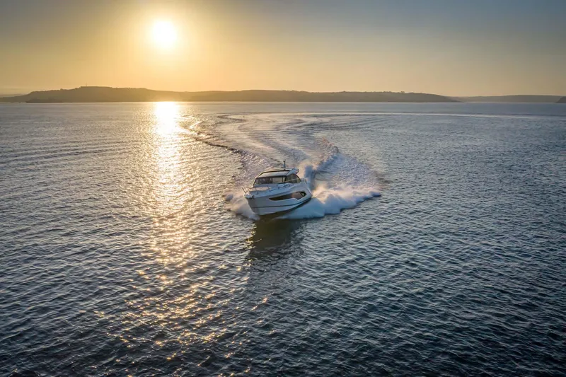 Slide: The Image of 2025 Princess V55 Express yacht cruising at sunset on open water. - 4