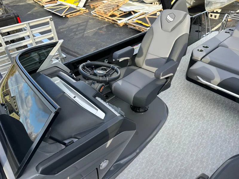 Slide: The Image of 2025 South Bay 525 ULDC boat interior with steering wheel and captain's chair. - 10