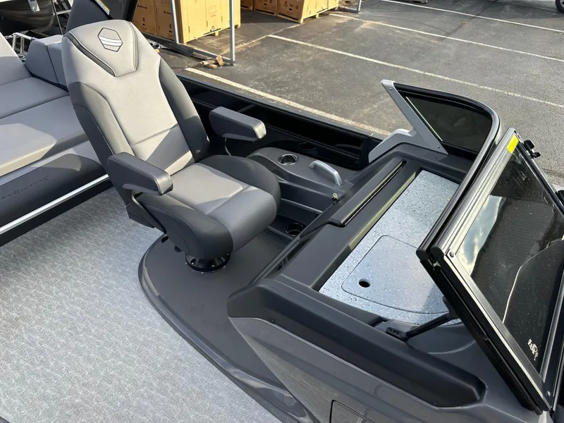 Slide: The Image of 2025 South Bay 525 ULDC boat interior with sleek captain's chair and modern dashboard. - 11