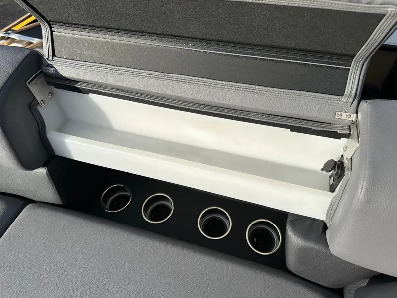 Slide: The Image of 2025 South Bay 525 ULDC boat storage compartment with cup holders. - 16