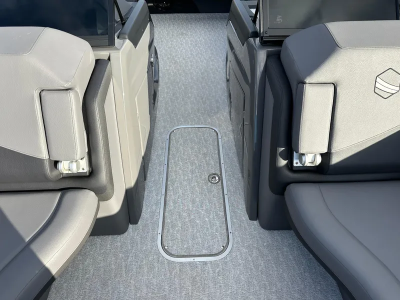Slide: The Image of 2025 South Bay 525 ULDC boat interior with gray seating and carpeted flooring. - 4