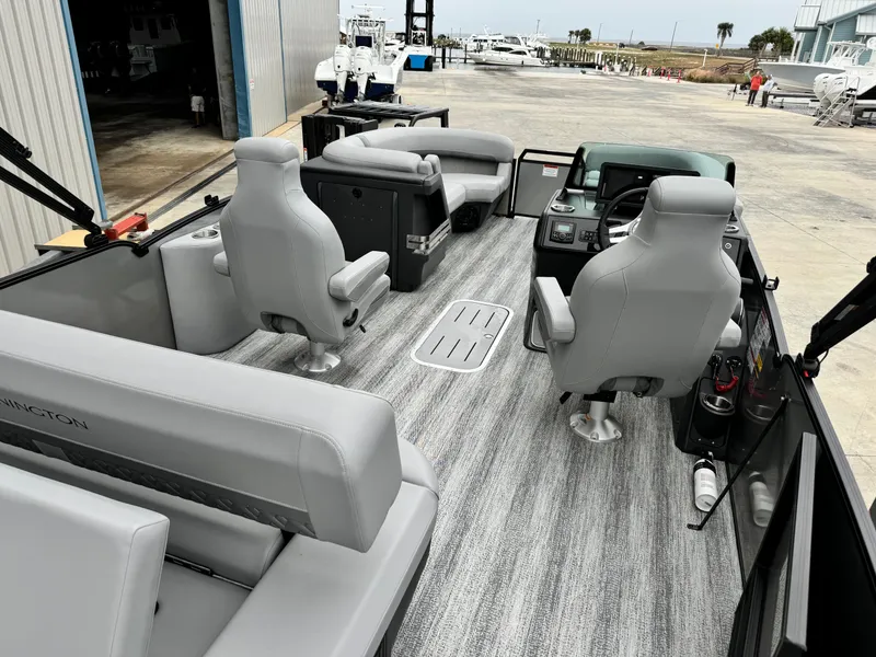 Slide: The Image of 2025 Bennington 22MSB pontoon boat interior with gray seating and modern dashboard. - 10
